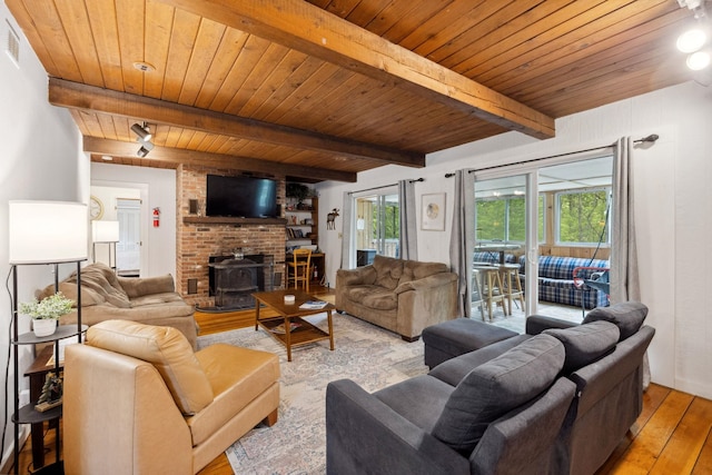 46 Crestwood Dr, Conway, NH 03860 - living room with hardwood / wood-style floors, wooden ceiling, beamed ceiling, and a wood stove
