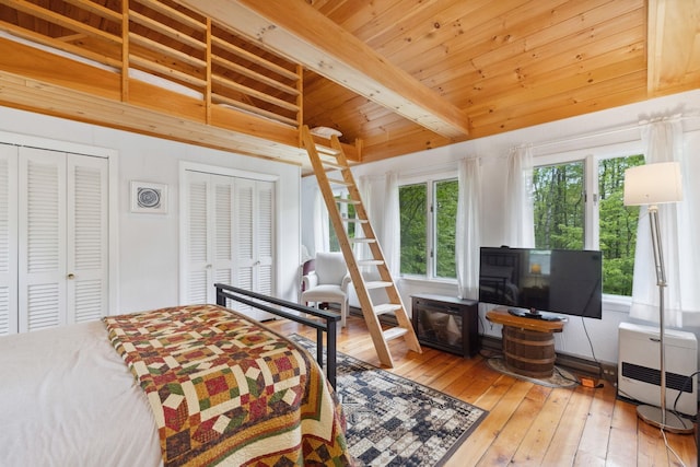 46 Crestwood Dr, Conway, NH 03860 - bedroom with wood ceiling, wood-type flooring, two closets, beamed ceiling, and heating unit
