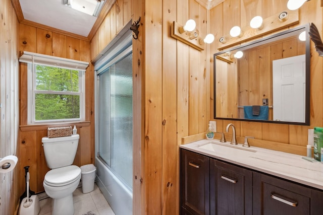 46 Crestwood Dr, Conway, NH 03860 - bathroom featuring wood walls, toilet, tile patterned floors, vanity, and combined bath / shower with glass door