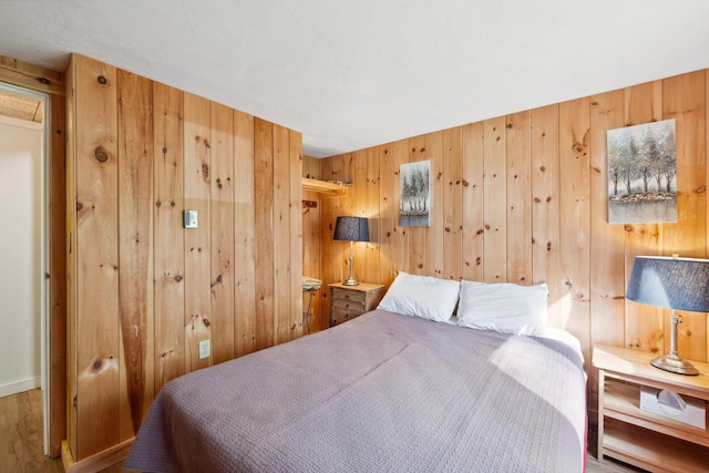 46 Crestwood Dr, Conway, NH 03860 - bedroom featuring wooden walls, wood finished floors, and baseboards