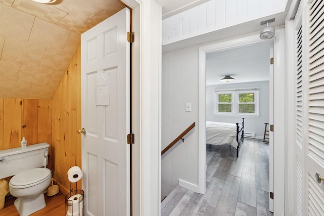 46 Crestwood Dr, Conway, NH 03860 - bathroom featuring wood finished floors, toilet, baseboard heating, lofted ceiling, and wood walls