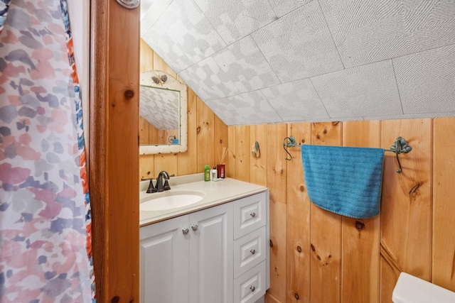 46 Crestwood Dr, Conway, NH 03860 - bathroom featuring wood walls, lofted ceiling, and vanity