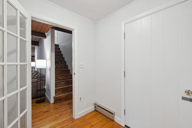 46 Crestwood Dr, Conway, NH 03860 - hallway with baseboard heating, light wood-style flooring, crown molding, stairs, and baseboards