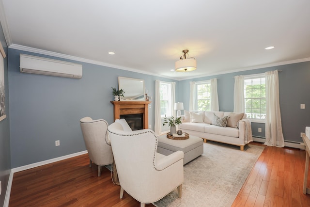 126 Oakcrest Ln, Gilmanton, NH 03237 - living area with an AC wall unit, crown molding, hardwood / wood-style flooring, a glass covered fireplace, and baseboards