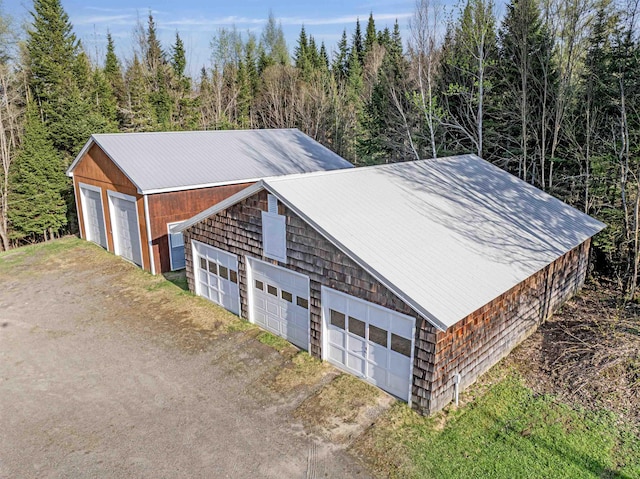 detached garage with dirt driveway