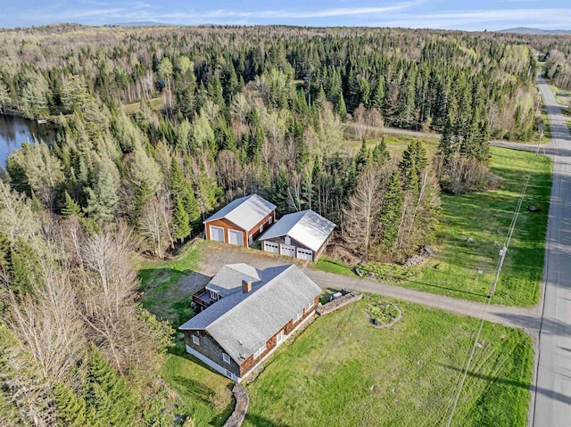 view of subject property featuring a heavily wooded area
