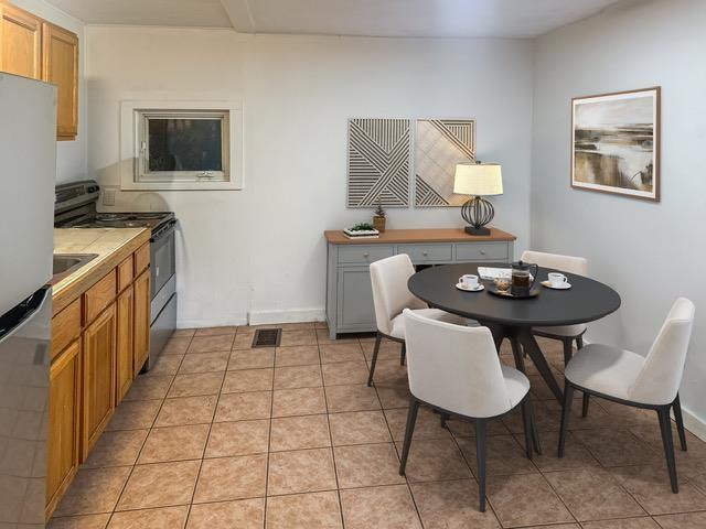 16 Shurtleff Pl, Barre City, VT 05641 - dining area featuring light tile patterned flooring and baseboards