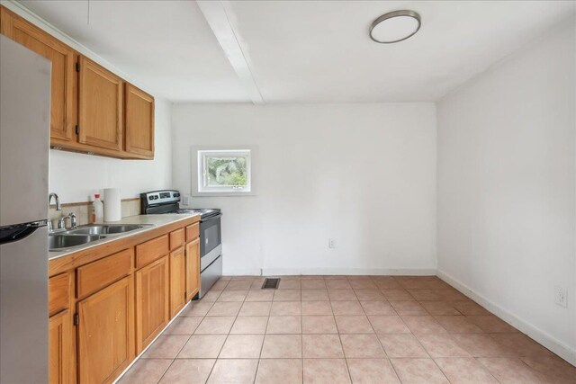 16 Shurtleff Pl, Barre City, VT 05641 - kitchen with stainless steel appliances, a sink, light countertops, and brown cabinets