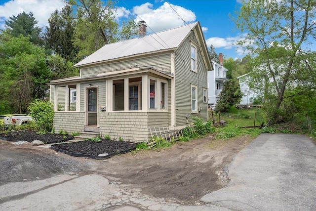 16 Shurtleff Pl, Barre City, VT 05641 - view of front of property featuring a chimney, entry steps, and metal roof