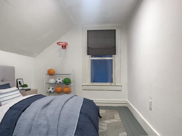 16 Shurtleff Pl, Barre City, VT 05641 - bedroom with vaulted ceiling, baseboards, and wood finished floors