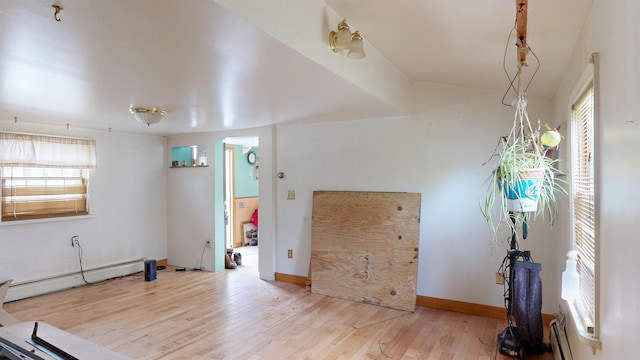 17 Convent Sq, Burlington, VT 05401 - unfurnished living room featuring a baseboard heating unit and wood finished floors