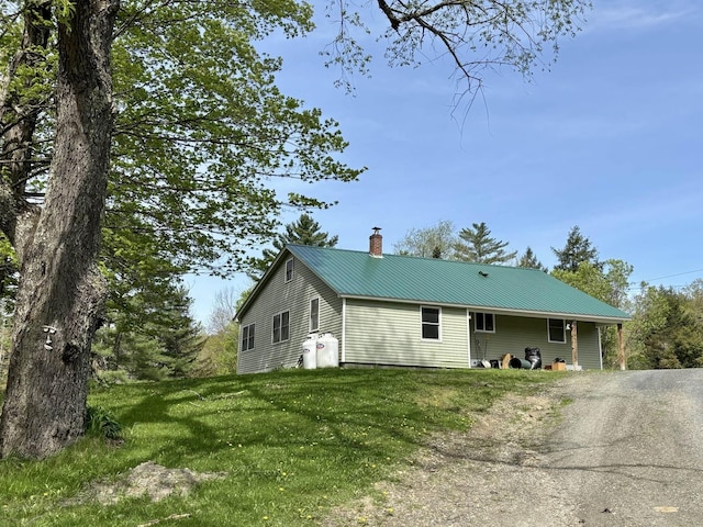 3742 N Fayston Rd, Fayston, VT 05660 - view of front of house with a chimney, metal roof, and a front lawn