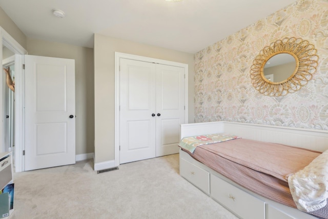 222 Standish Ln, Hudson, NH 03051 - bedroom with wallpapered walls, a closet, light colored carpet, and a wainscoted wall
