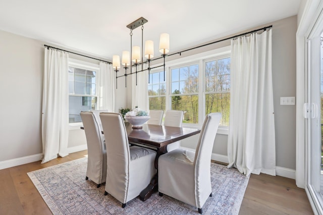 222 Standish Ln, Hudson, NH 03051 - dining room with a chandelier, plenty of natural light, and wood finished floors