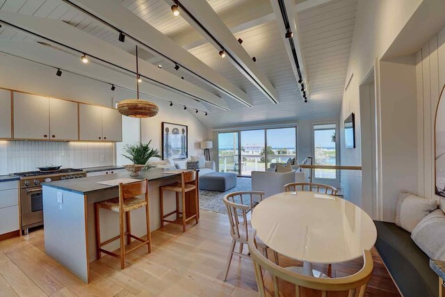 797 Ocean Blvd, Rye, NH 03870 - kitchen featuring rail lighting, high end stainless steel range oven, open floor plan, and dark countertops