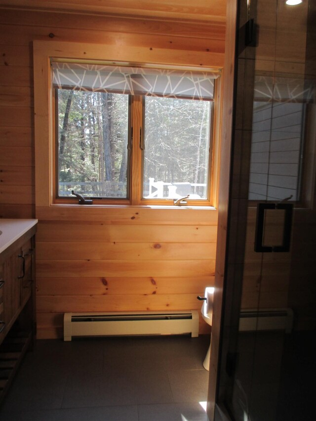 42 Chickadee Ln, Littleton, NH 03561 - bathroom featuring wood walls, baseboard heating, healthy amount of natural light, tile patterned floors, and vanity