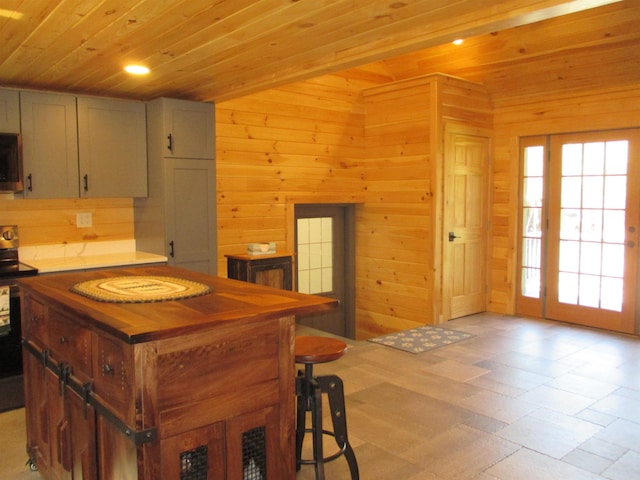 42 Chickadee Ln, Littleton, NH 03561 - kitchen featuring electric stove, stainless steel microwave, wooden ceiling, wood walls, and recessed lighting