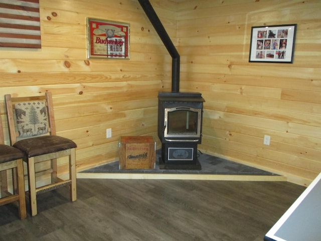 42 Chickadee Ln, Littleton, NH 03561 - living area featuring a wood stove, wood finished floors, and wooden walls