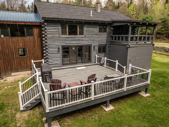 42 Chickadee Ln, Littleton, NH 03561 - back of property featuring log exterior, a lawn, a deck, and roof with shingles