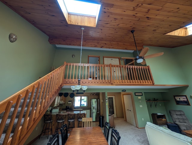 11 Cascade Dr Unit 288, Woodstock, NH 03262 - dining space featuring a skylight, light carpet, stairs, ceiling fan, and high vaulted ceiling