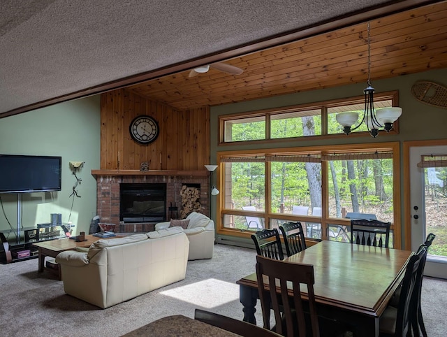 11 Cascade Dr Unit 288, Woodstock, NH 03262 - carpeted living area with vaulted ceiling, healthy amount of natural light, a brick fireplace, and wood walls