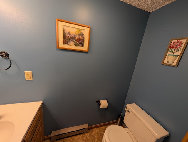 11 Cascade Dr Unit 288, Woodstock, NH 03262 - bathroom featuring a baseboard radiator, toilet, vanity, and a textured ceiling