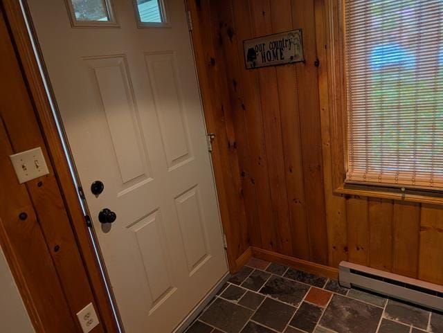 11 Cascade Dr Unit 288, Woodstock, NH 03262 - doorway featuring a baseboard heating unit, dark stone finish floors, wooden walls, and baseboards