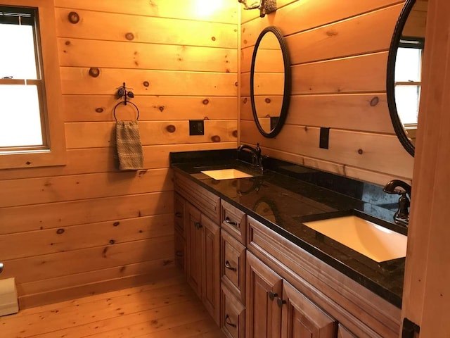 42 Peak Vista Ln, Madison, NH 03849 - full bath featuring double vanity, wooden walls, wood-type flooring, and healthy amount of natural light