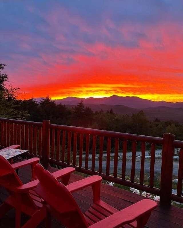 42 Peak Vista Ln, Madison, NH 03849 - deck at dusk with a mountain view