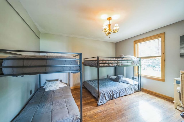 42 Peak Vista Ln, Madison, NH 03849 - bedroom featuring wood finished floors, a chandelier, and baseboards