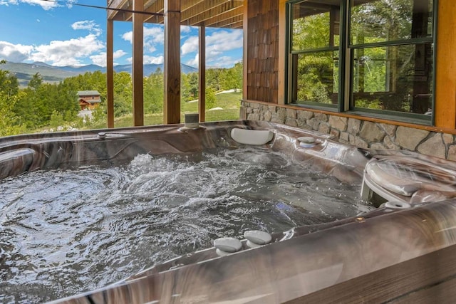 42 Peak Vista Ln, Madison, NH 03849 - exterior view of a jacuzzi, mountains, and stone siding