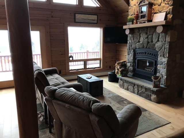 42 Peak Vista Ln, Madison, NH 03849 - living room featuring wood walls, plenty of natural light, wood finished floors, vaulted ceiling, and a fireplace