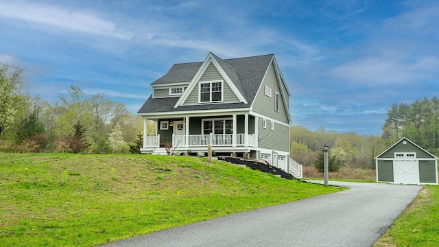 21 Lovering Rd, North Hampton, NH 03862 - view of front facade with an outdoor structure, a porch, roof with shingles, a front lawn, and a detached garage