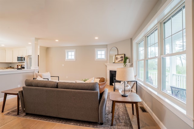 21 Lovering Rd, North Hampton, NH 03862 - living room featuring light wood-style flooring, a glass covered fireplace, baseboards, and recessed lighting