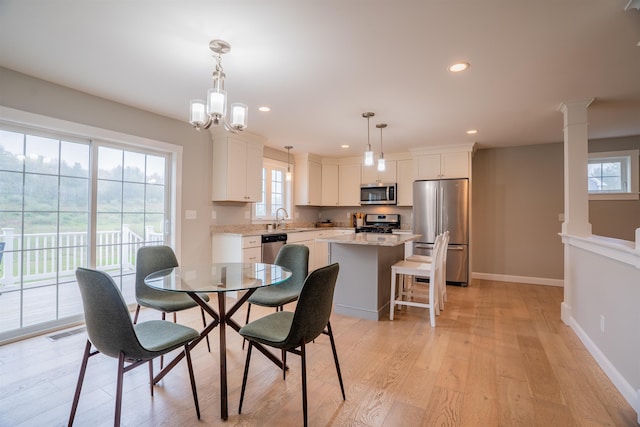 21 Lovering Rd, North Hampton, NH 03862 - dining space with light wood-type flooring, baseboards, recessed lighting, plenty of natural light, and a chandelier