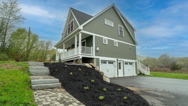 21 Lovering Rd, North Hampton, NH 03862 - view of side of home with a garage, stairway, and driveway