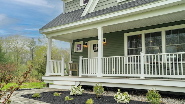 21 Lovering Rd, North Hampton, NH 03862 - view of exterior entry featuring roof with shingles and covered porch