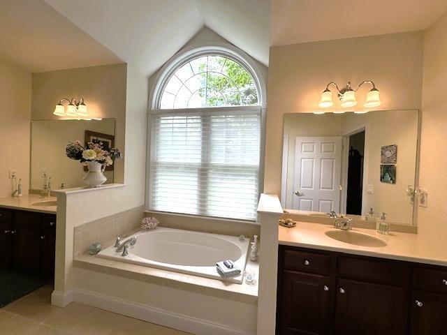 7 Ebenezers Way, Hollis, NH 03049 - full bath featuring two vanities, a bath, lofted ceiling, and tile patterned floors