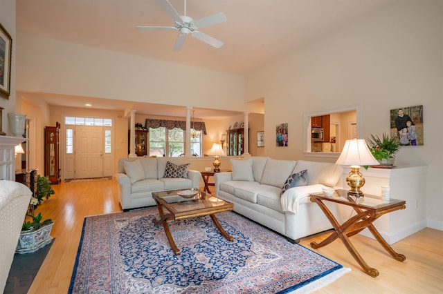7 Ebenezers Way, Hollis, NH 03049 - living area featuring wood finished floors, a high ceiling, ceiling fan, decorative columns, and baseboards