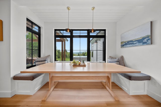 dining area with breakfast area, wood finished floors, and baseboards