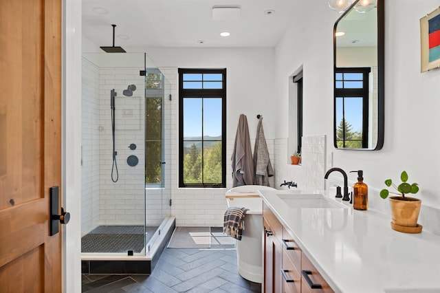 bathroom with a stall shower, vanity, and recessed lighting