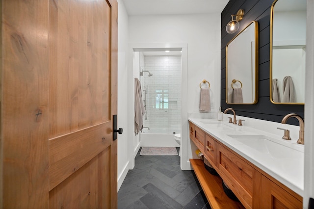 bathroom featuring toilet, double vanity, and bathing tub / shower combination