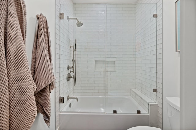 full bathroom with enclosed tub / shower combo and toilet