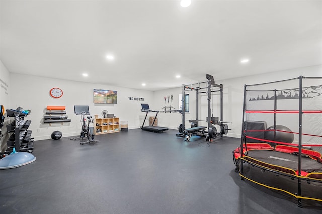exercise room with recessed lighting and baseboards