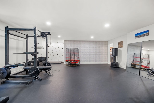 exercise room with wallpapered walls, baseboards, and recessed lighting