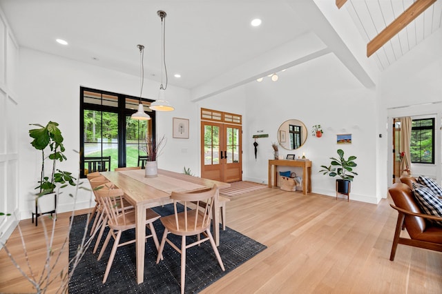 dining room featuring french doors, light wood-type flooring, beamed ceiling, recessed lighting, and baseboards