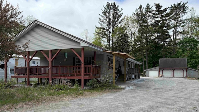 view of front of house featuring a garage and an outbuilding