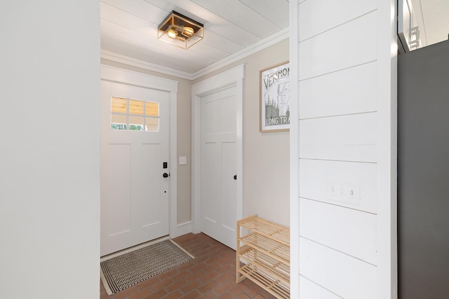 entrance foyer featuring brick floors and crown molding