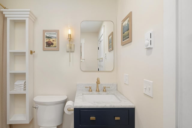 bathroom with toilet and vanity