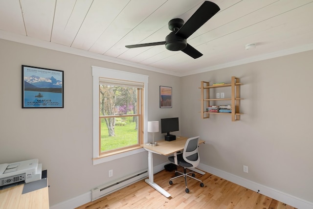 office space with a baseboard radiator, ceiling fan, wood finished floors, crown molding, and baseboards